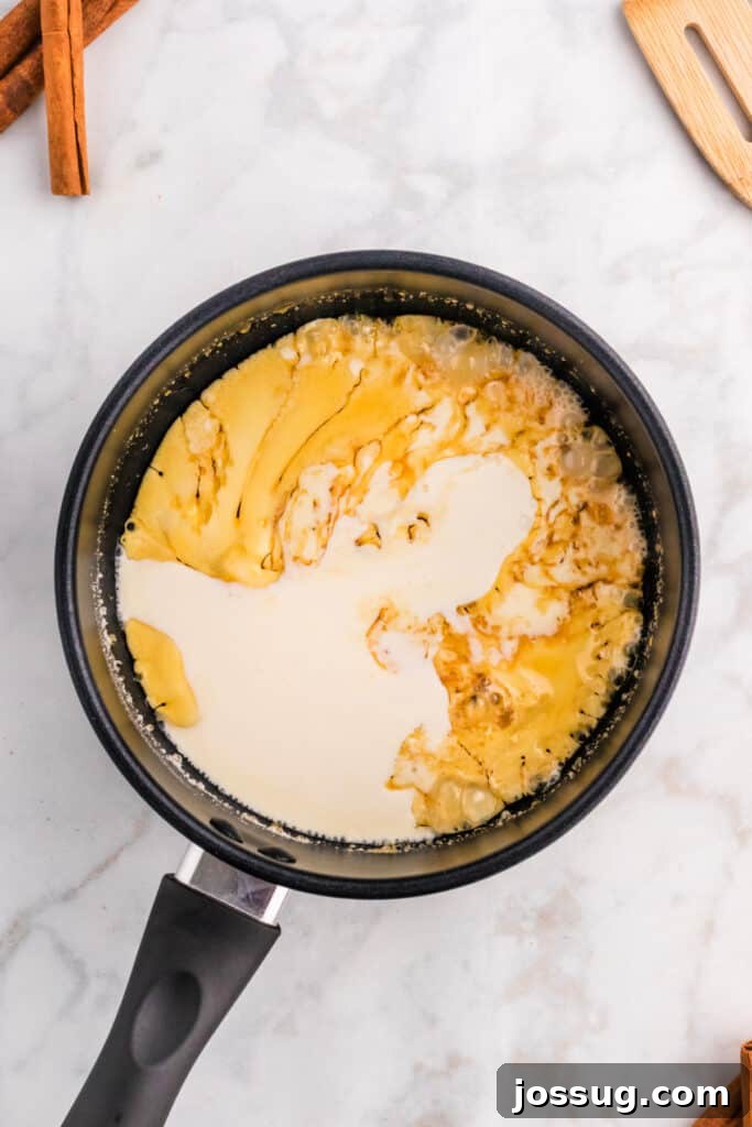 Heavy cream being slowly added to a rich caramelized sugar mixture, creating a delightful sizzle as spiced caramel sauce comes to life.