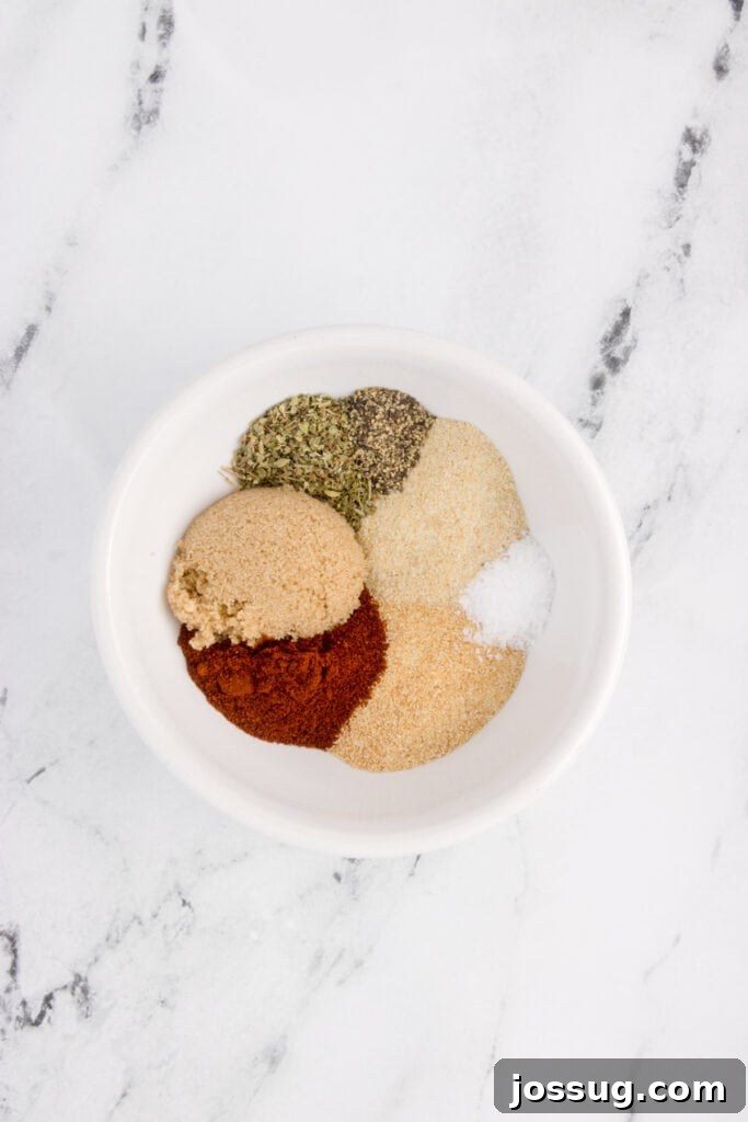 Close-up of spices for blackened salmon seasoning arranged neatly in a white bowl.
