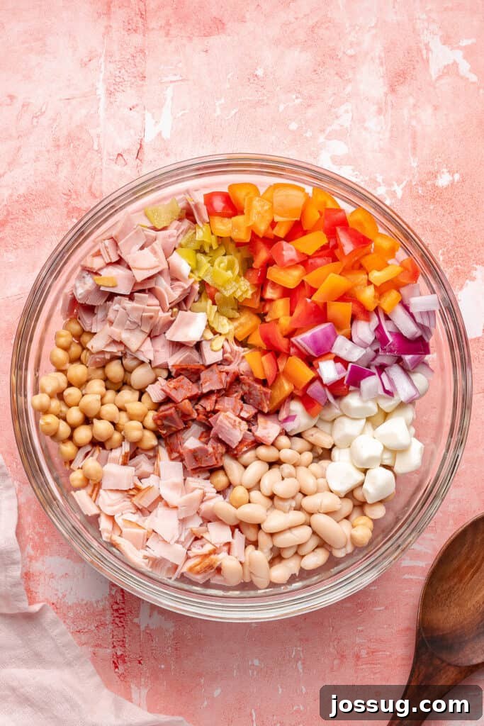 Grinding Bean Power Salad 3 Glass mixing bowl filled with salad ingredients arranged in sections before mixing.