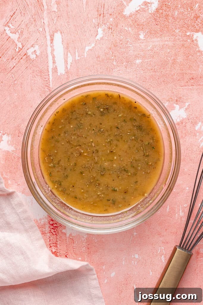 Grinding Bean Power Salad 6 Prepared vinaigrette after whisking, smooth and emulsified, in a small glass bowl.