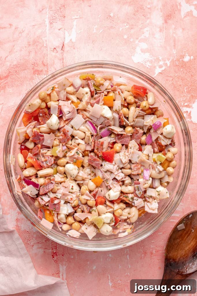 Grinding Bean Power Salad 8 Fully mixed grinder dense bean salad in a large glass bowl ready to serve.