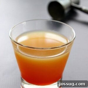 A perfectly mixed Phoenix Sunset Margarita cocktail with vibrant layers of orange and red, ready to be enjoyed.