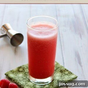 Vibrant Raspberry Margarita in a glass with fresh raspberries
