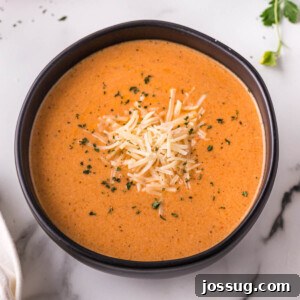 creamy tomato soup in black bowl