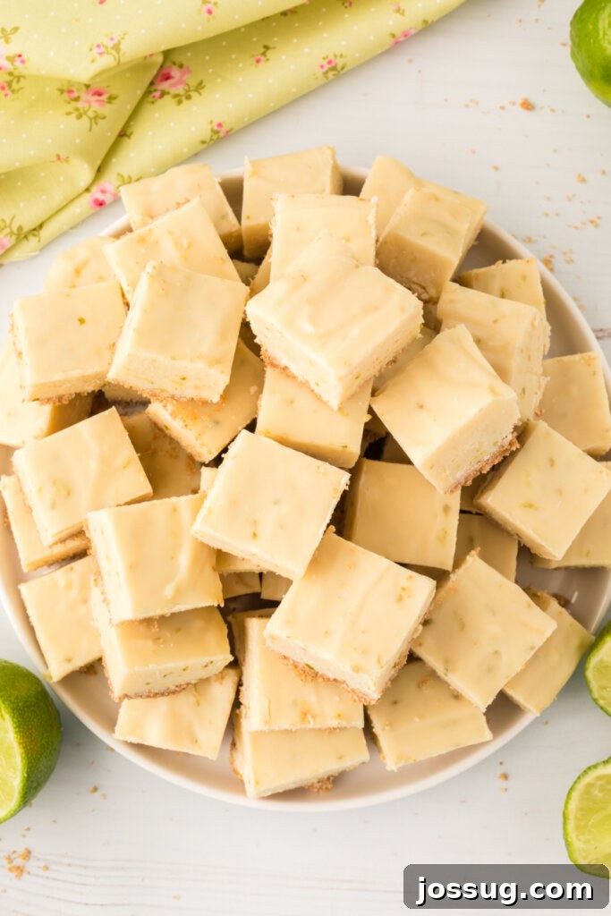 Close-up of a plate with perfectly cut, square pieces of key lime fudge, highlighting the creamy texture and hint of green