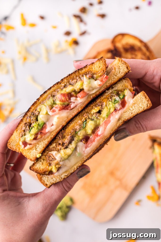 Grilled Taco Melt 2 hands holding taco stuffed grilled cheese sandwich