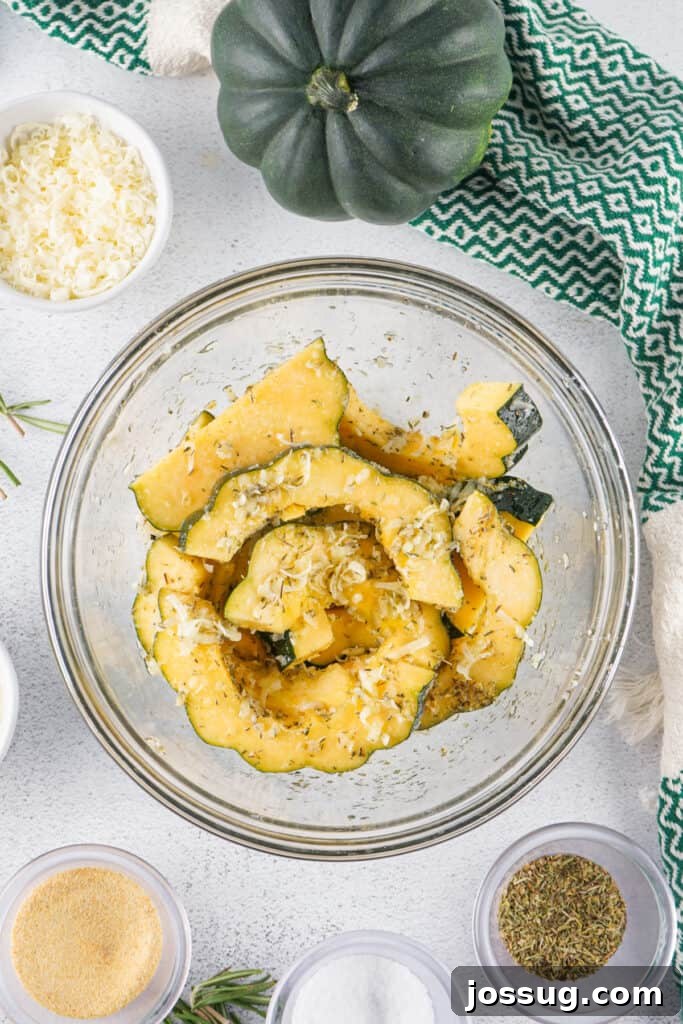 Caramelized Acorn Squash 9 Mixing bowl filled with sliced acorn squash tossed with cheese and seasonings before roasting.
