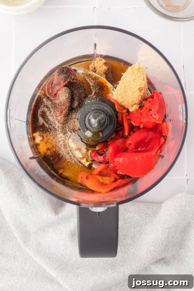 Smoky Sweet Air Fryer Chipotle Honey Glazed Wings 9 Ingredients for chipotle honey sauce placed inside a food processor bowl before blending.