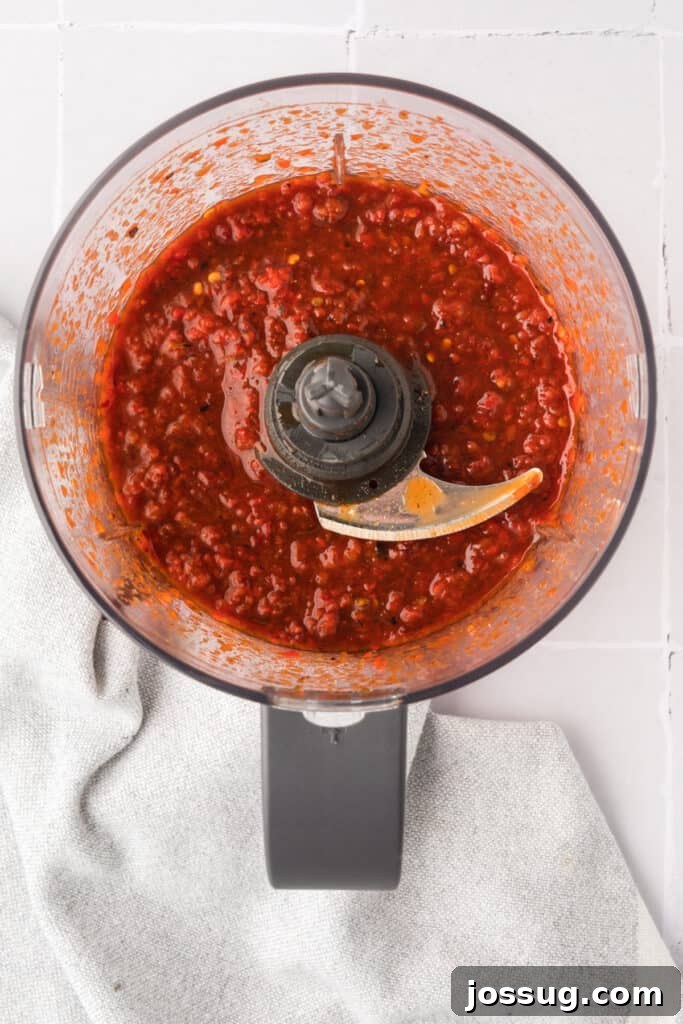 Smoky Sweet Air Fryer Chipotle Honey Glazed Wings 10 Blended chipotle honey sauce mixture inside a food processor bowl with visible red pepper and chili flecks.