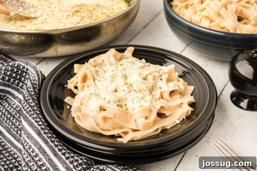 pasta with better for you alfredo sauce on black plate