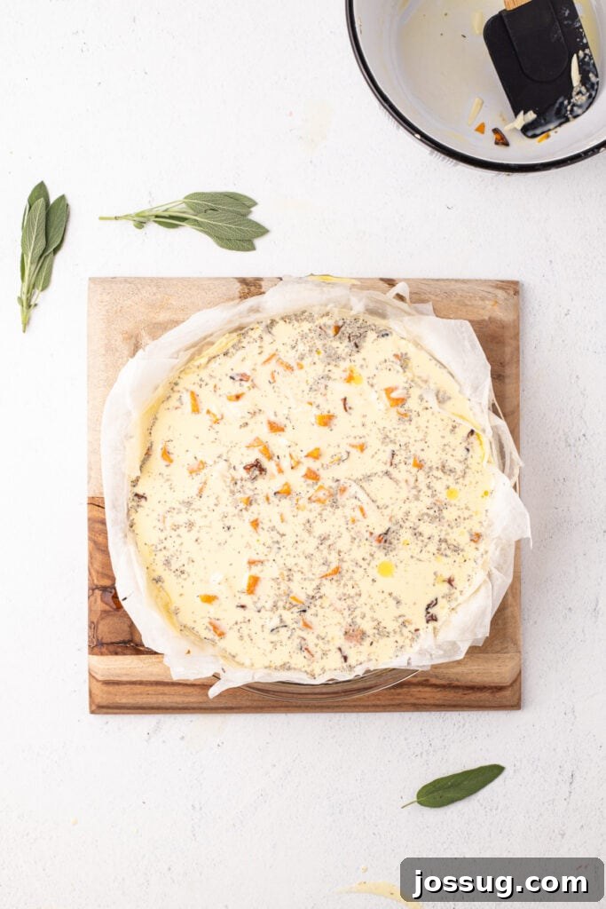 Prepared phyllo crust filled with uncooked quiche mixture of eggs, squash, cheese, cream, and herbs, ready for the oven.