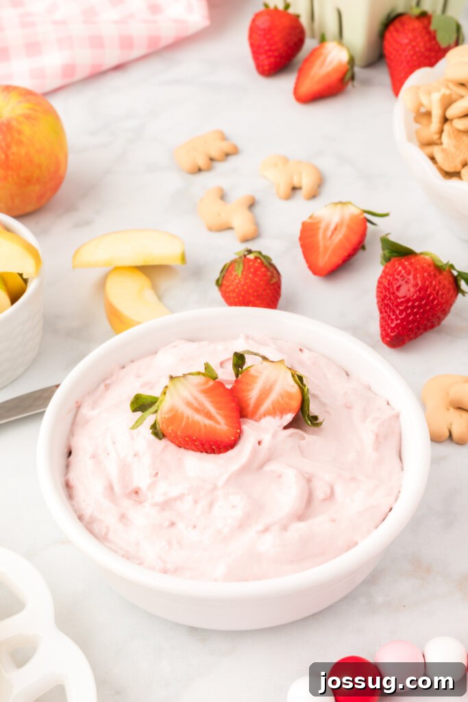 strawberry cream cheese fruit dip garnished with cut strawberry