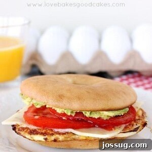 A deliciously stacked Southwest Breakfast Sandwich with a fried egg, cheese, tomato, and avocado on a toasted bagel.