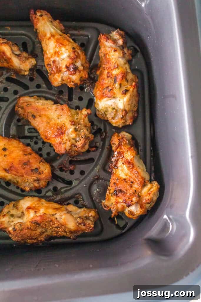 Crispy Air Fryer Ranch Wings 11 Cooked chicken wings golden brown and crispy inside an air fryer basket