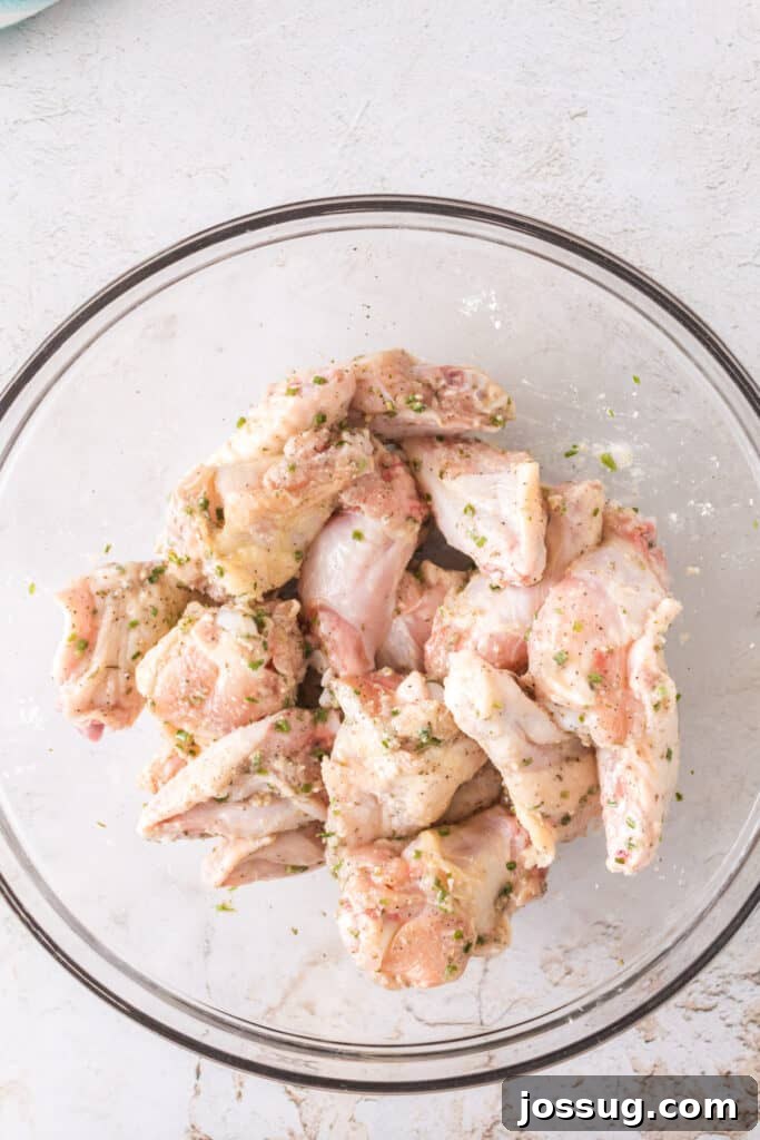 Crispy Air Fryer Ranch Wings 9 Seasoned chicken wings tossed together and ready to cook in a glass bowl