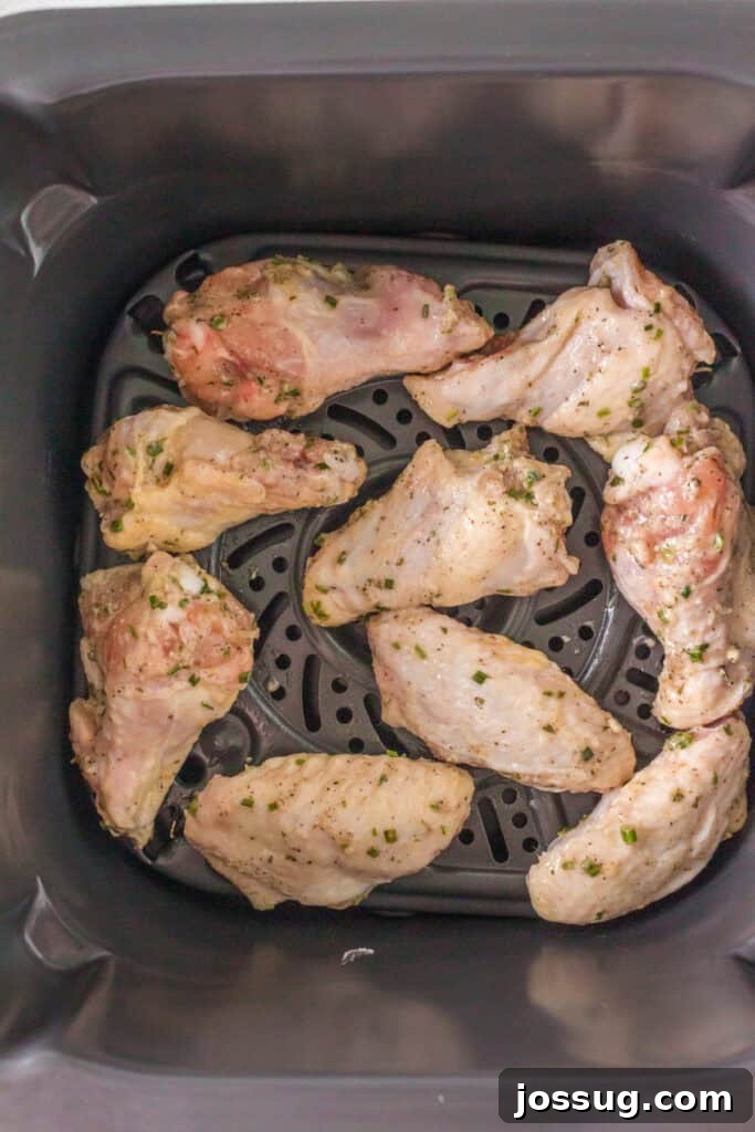 Crispy Air Fryer Ranch Wings 10 Raw seasoned chicken wings placed in the basket of an air fryer