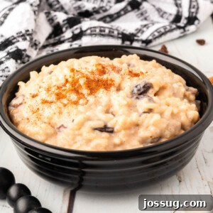 A black bowl featuring creamy Arroz con Leche, or Mexican Rice Pudding, perfect for a cozy meal.
