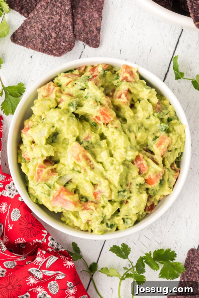 A top-down view of a bowl of fresh, homemade guacamole.