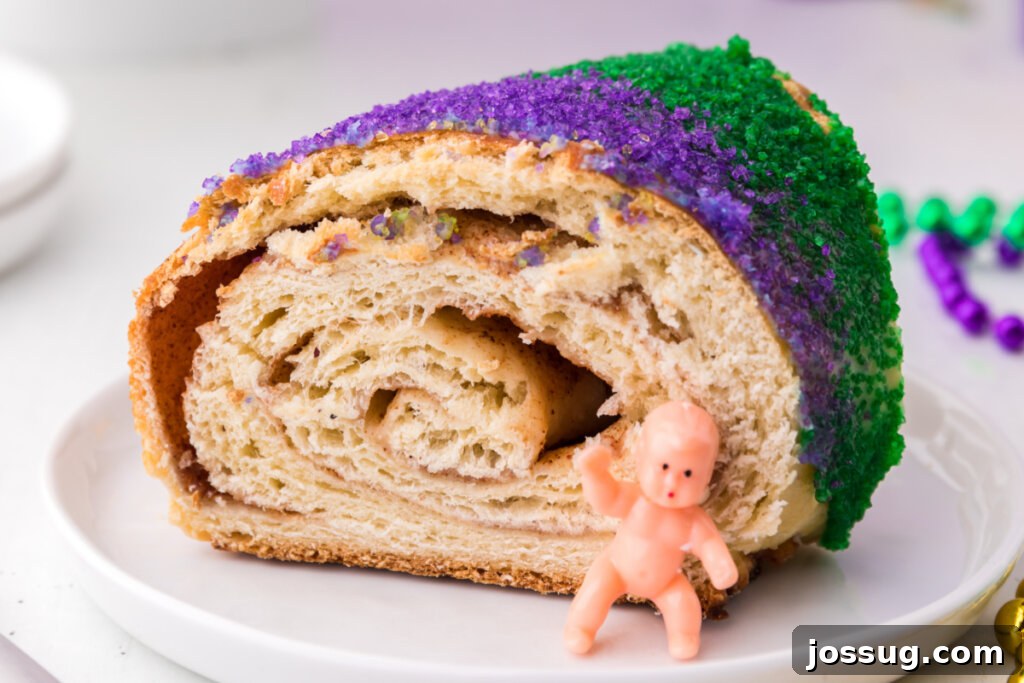 New Orleans Mardi Gras King Cake 6 A delicious slice of New Orleans King Cake with the tiny plastic baby figurine clearly visible, indicating the finder's good fortune.