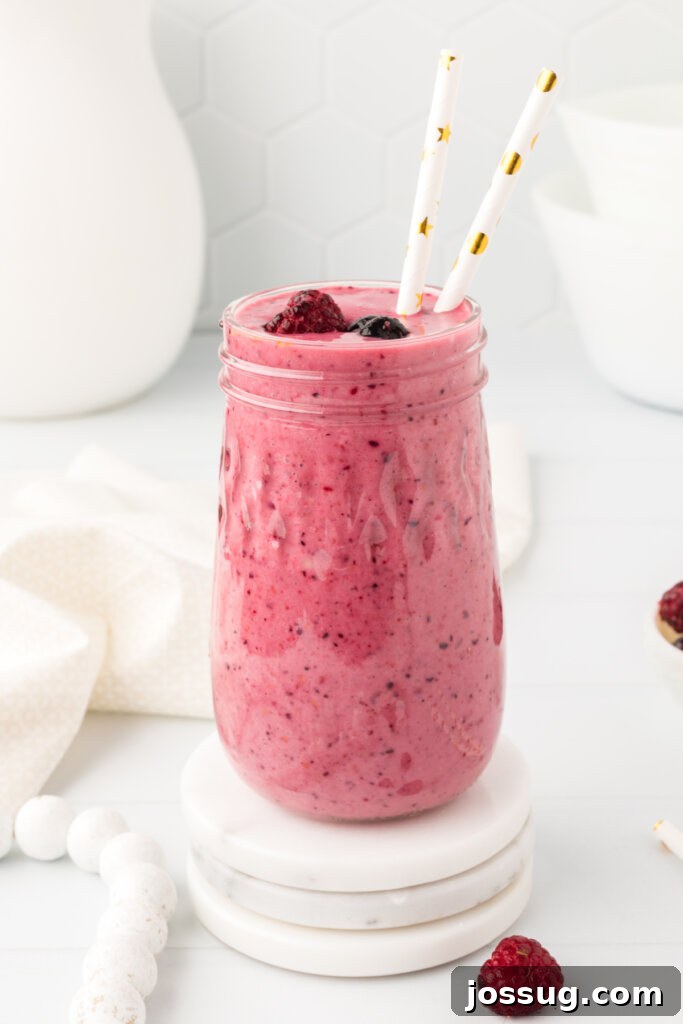 glass filled with banana berry smoothie, ready to enjoy