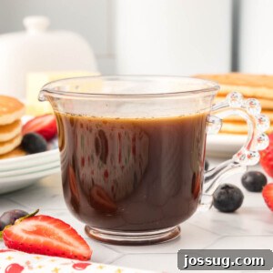 Golden Vanilla Pancake Nectar 7 Homemade vanilla pancake syrup in a clear glass container, showcasing its inviting golden hue.