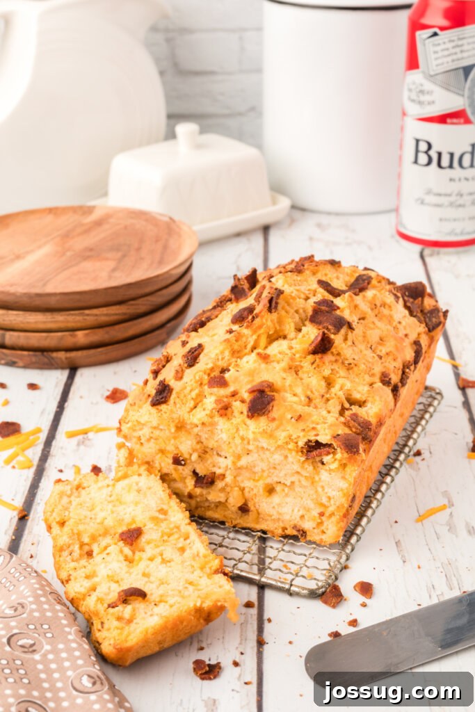 Smoked Bacon & Cheddar Ale Loaf 4 a freshly baked loaf of bacon cheddar beer bread next to a glass of beer
