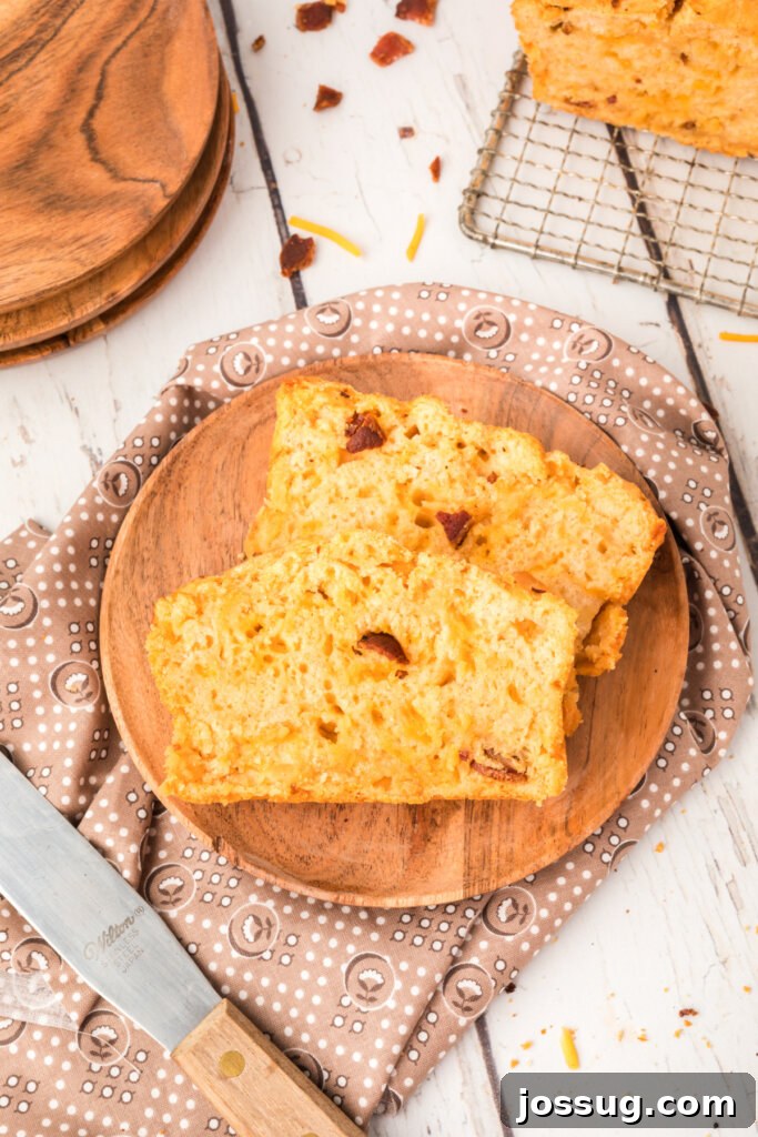 Smoked Bacon & Cheddar Ale Loaf 5 two thick slices of bacon cheddar beer bread served on a rustic wooden plate