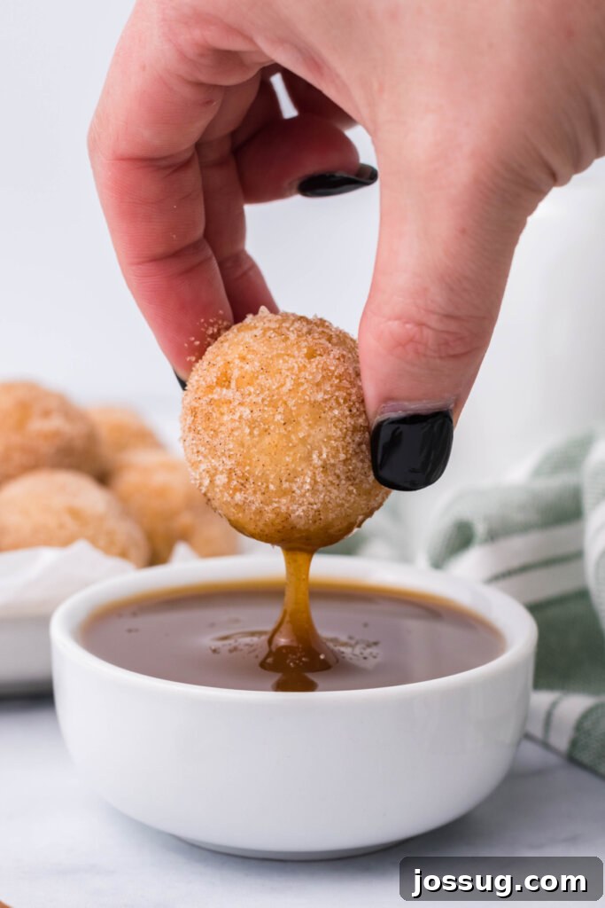 Poppable Churros 3 churros poppers arranged for a party, with a bowl of rich caramel sauce for dipping