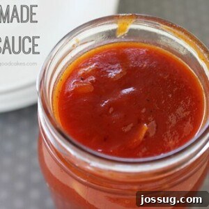 A glass jar filled with rich, homemade BBQ sauce, ready to be enjoyed.