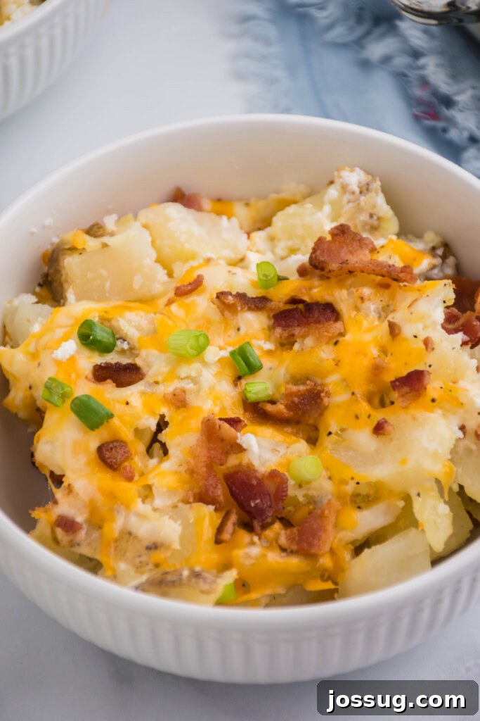A beautifully golden-brown Twice-Baked Potato Casserole in a large glass baking dish, ready to be served, highlighting its irresistible texture.
