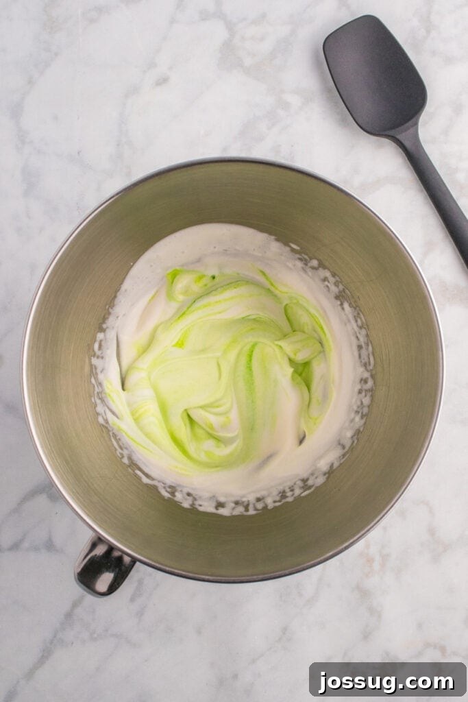 Biohazard Brew 11 Mixing bowl with beautifully swirled green and white whipped cream, expertly blended to create a visually striking toxic waste foam effect.
