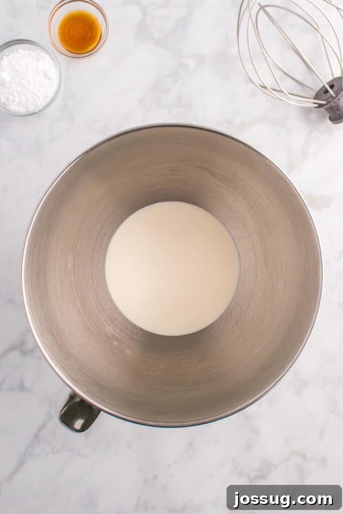 Biohazard Brew 8 Mixing bowl with heavy cream at the bottom, ready to be whipped with a whisk attachment and a bottle of vanilla extract nearby, prepping for foam.