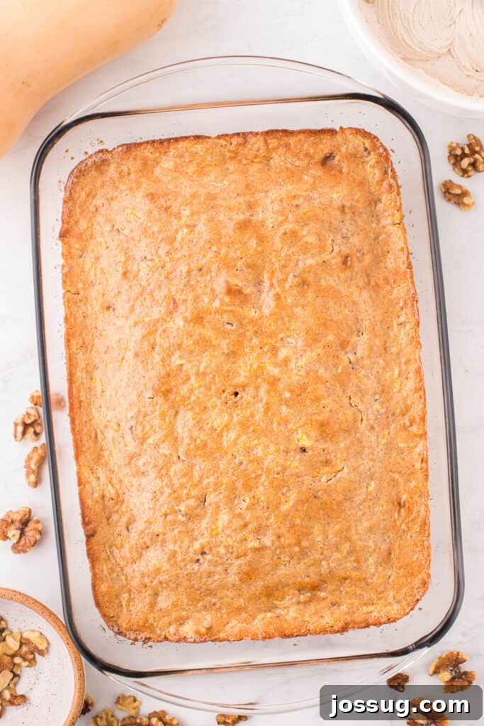 Spiced Golden Butternut Cake 11 An inviting overhead perspective reveals the golden, baked butternut squash cake nestled in a glass dish, poised and ready for its creamy frosting.