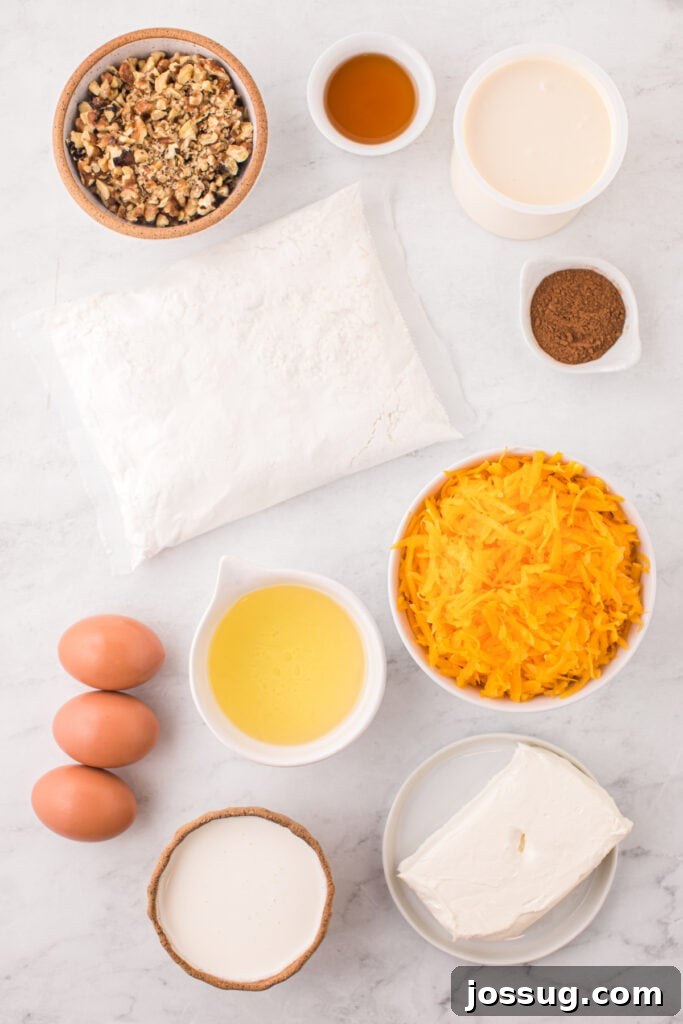 Spiced Golden Butternut Cake 3 An inviting overhead view captures all the essential ingredients for a delicious butternut squash cake: golden walnuts, farm-fresh eggs, vibrant grated squash, rich heavy cream, cooking oil, creamy cream cheese, convenient cake mix, pure maple syrup, and a medley of aromatic spices, all neatly arranged on a clean white surface.