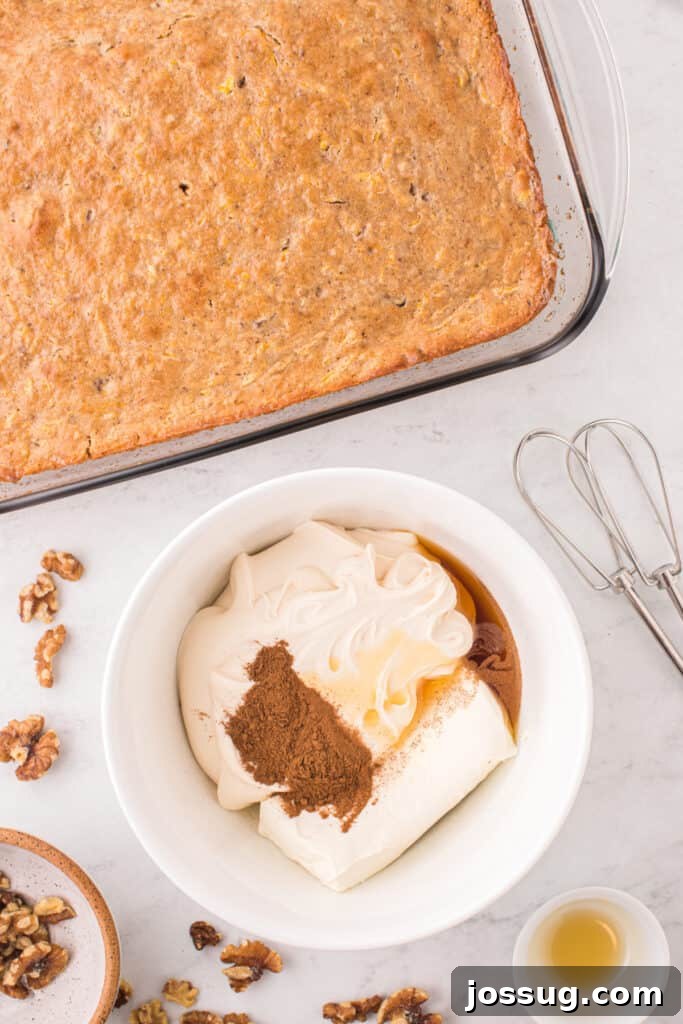Spiced Golden Butternut Cake 9 The freshly baked butternut squash cake cools in its glass dish, positioned beside a bowl brimming with the essential ingredients for its luscious cream cheese frosting.