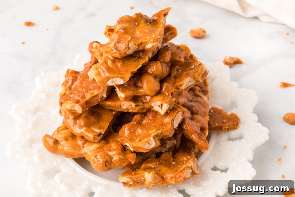 A wider shot of microwave peanut brittle presented on a plate, showcasing its golden texture.
