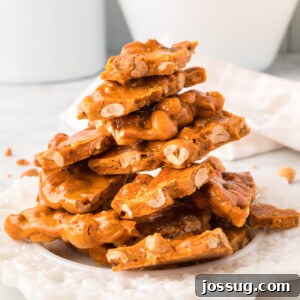 microwave peanut brittle stacked on a white plate