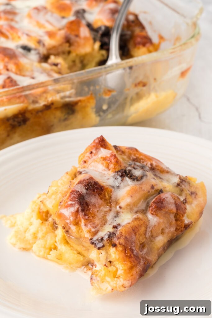 Warm Cinnamon Roll Bread Bliss 2 Slice of Cinnamon Roll Bread Pudding on a plate, garnished with icing