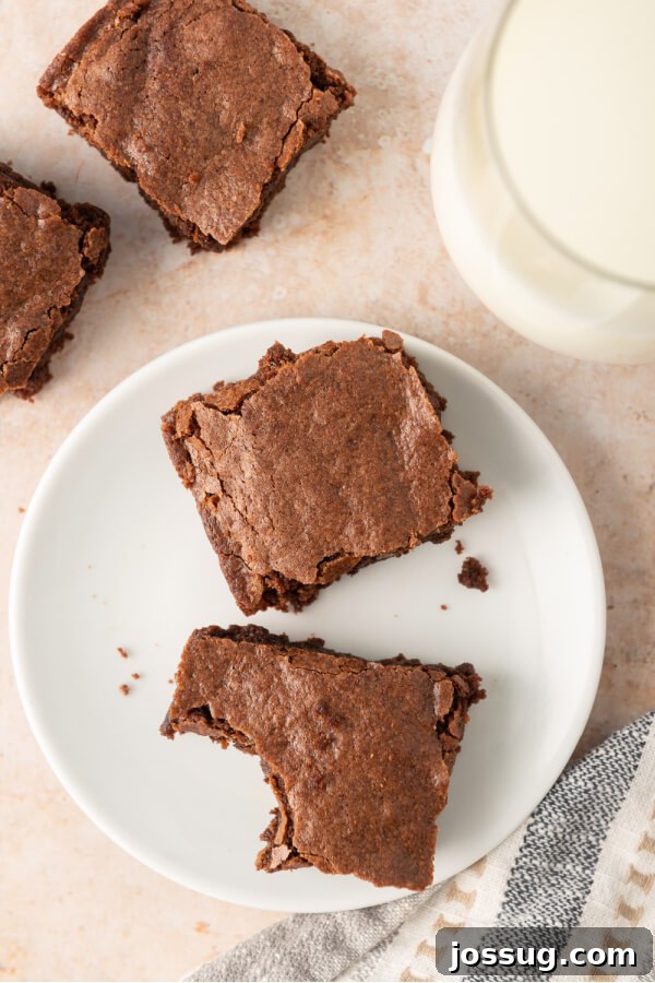Foolproof Homemade Chocolate Brownies 2 Delicious cut chocolate brownies on a plate, one with a bite taken out, showcasing their fudgy texture