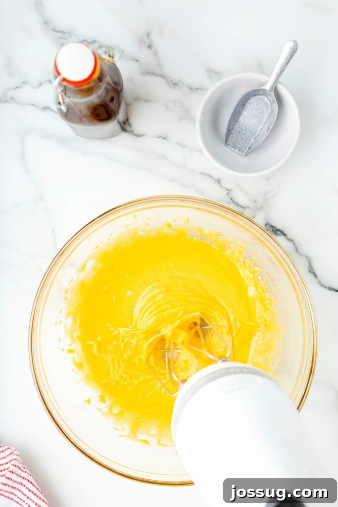 Classic Homemade Eggnog 6 Egg yolks and sugar whipped until pale and fluffy with an electric mixer in a glass bowl.