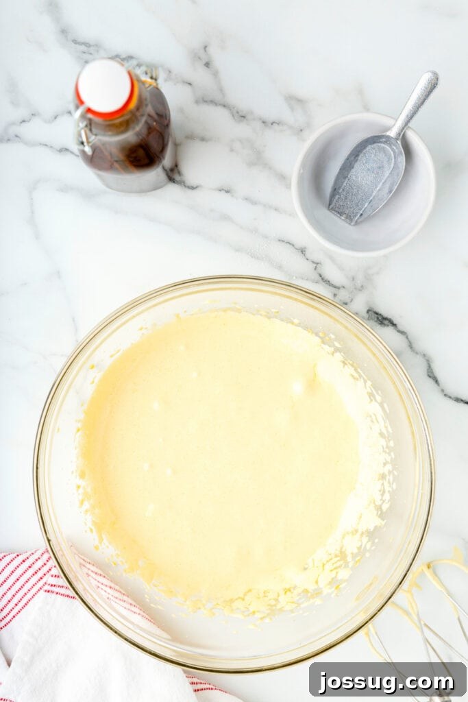 Classic Homemade Eggnog 10 Fluffy egg yolk and sugar mixture in a glass mixing bowl after beating.