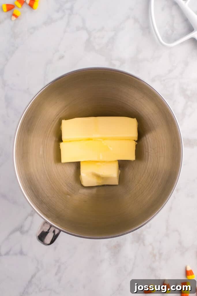 Mixing bowl with sticks of butter ready to be beaten for frosting.