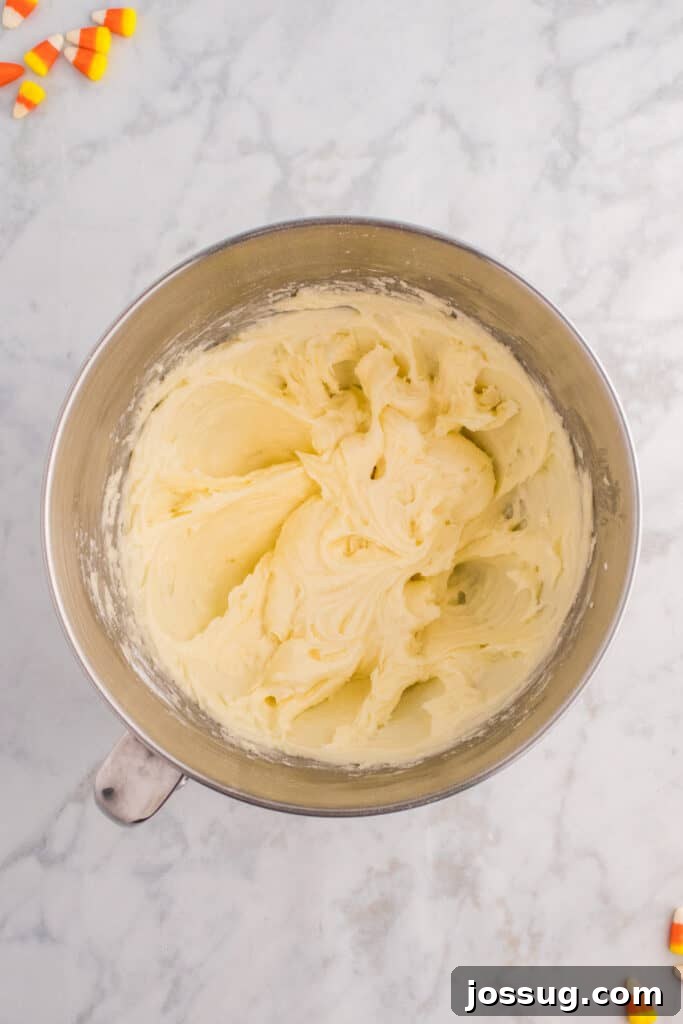 Smooth and fluffy white frosting fully mixed and ready for piping.