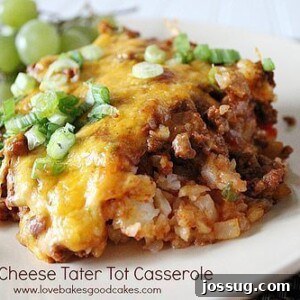 Loaded Chili Cheese Tater Tot Bake 2 A steaming hot Chili Cheese Tater Tot Casserole in a baking dish, topped with melted cheddar cheese and sliced green onions. Golden-brown tater tots peek out from beneath a rich layer of chili.