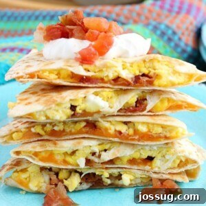 Savory Bacon Egg and Cheese Quesadillas 2 A close up view of the finished breakfast quesadillas recipe with salsa and sour cream ready to be shared!
