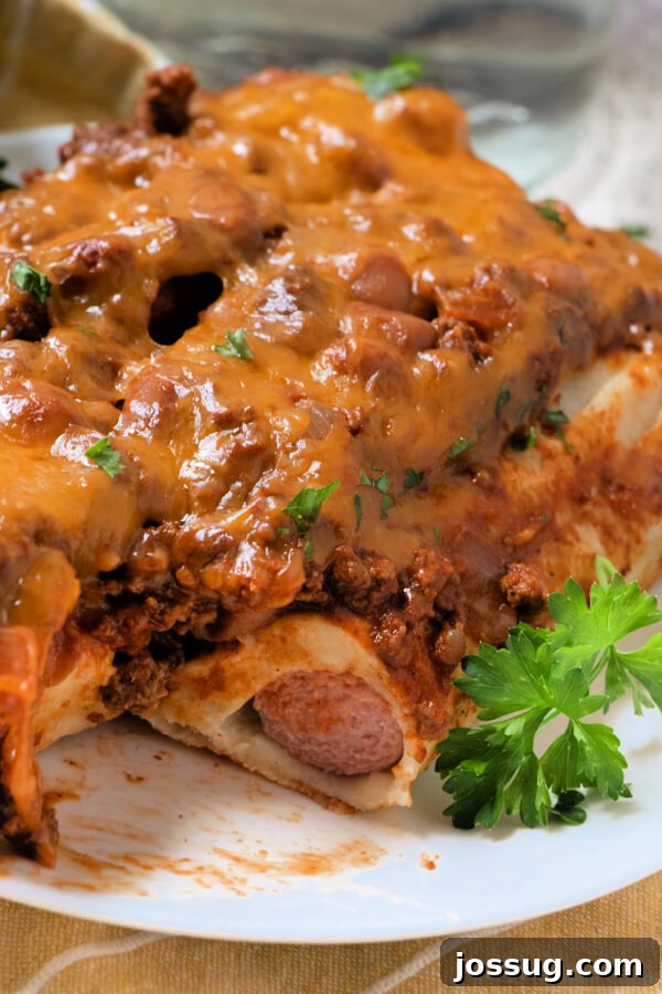 Cheesy Chili Dog Bake 2 chili dog casserole on plate, freshly baked and topped with cheese