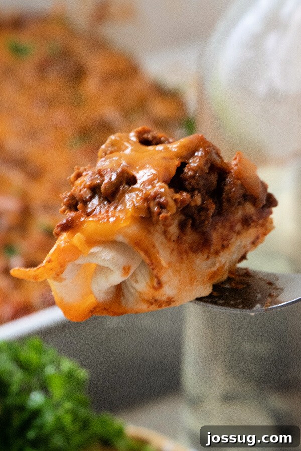 Cheesy Chili Dog Bake 6 a bite of chili dog casserole on a fork, showing the layers
