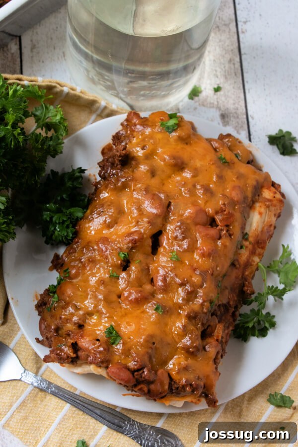 Cheesy Chili Dog Bake 7 looking down onto a portion of the finished chili dog casserole on a plate, ready to eat
