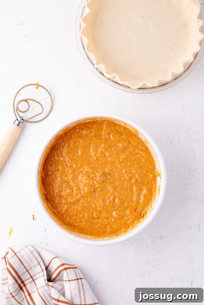 Sunshine Sweetness Pie 6 Sweet potato pie filling in a bowl next to an unbaked pie crust ready for assembly.