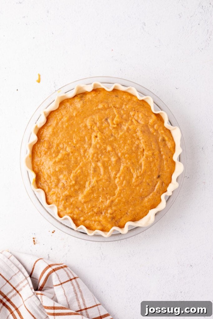 Sunshine Sweetness Pie 7 Unbaked sweet potato pie filled with smooth orange filling, ready to go into the oven.